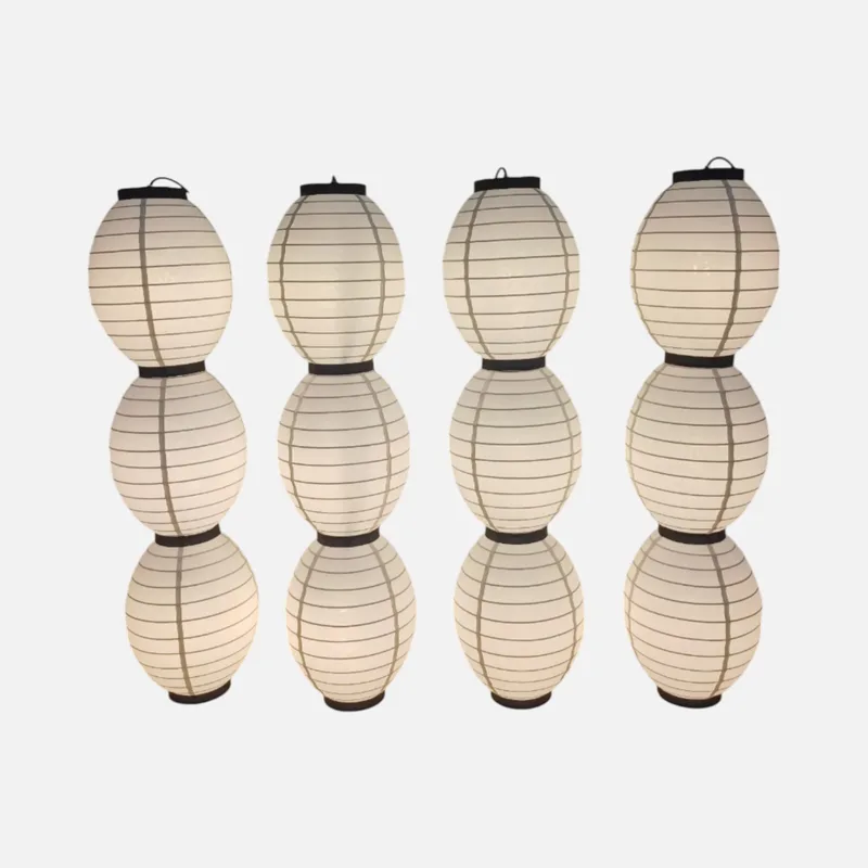 Cụm đèn chùm vải nhiều chuỗi, mỗi chuỗi ba bóng dáng oval xếp dọc, vải kem, khung viền đen
